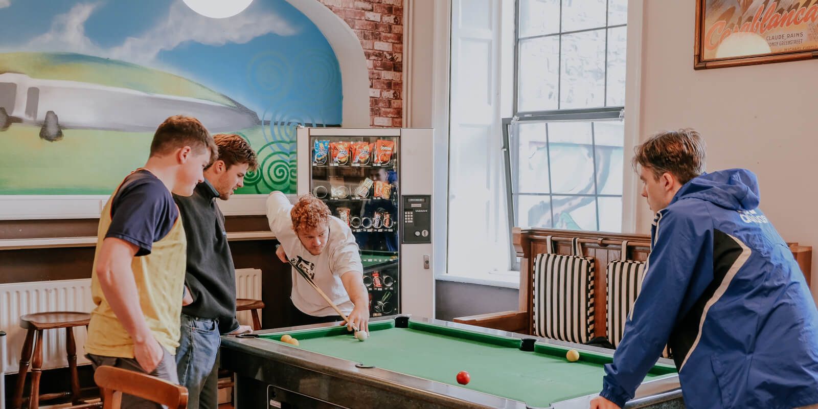 Guests playing pool at Gardiner House Hostel in Dublin