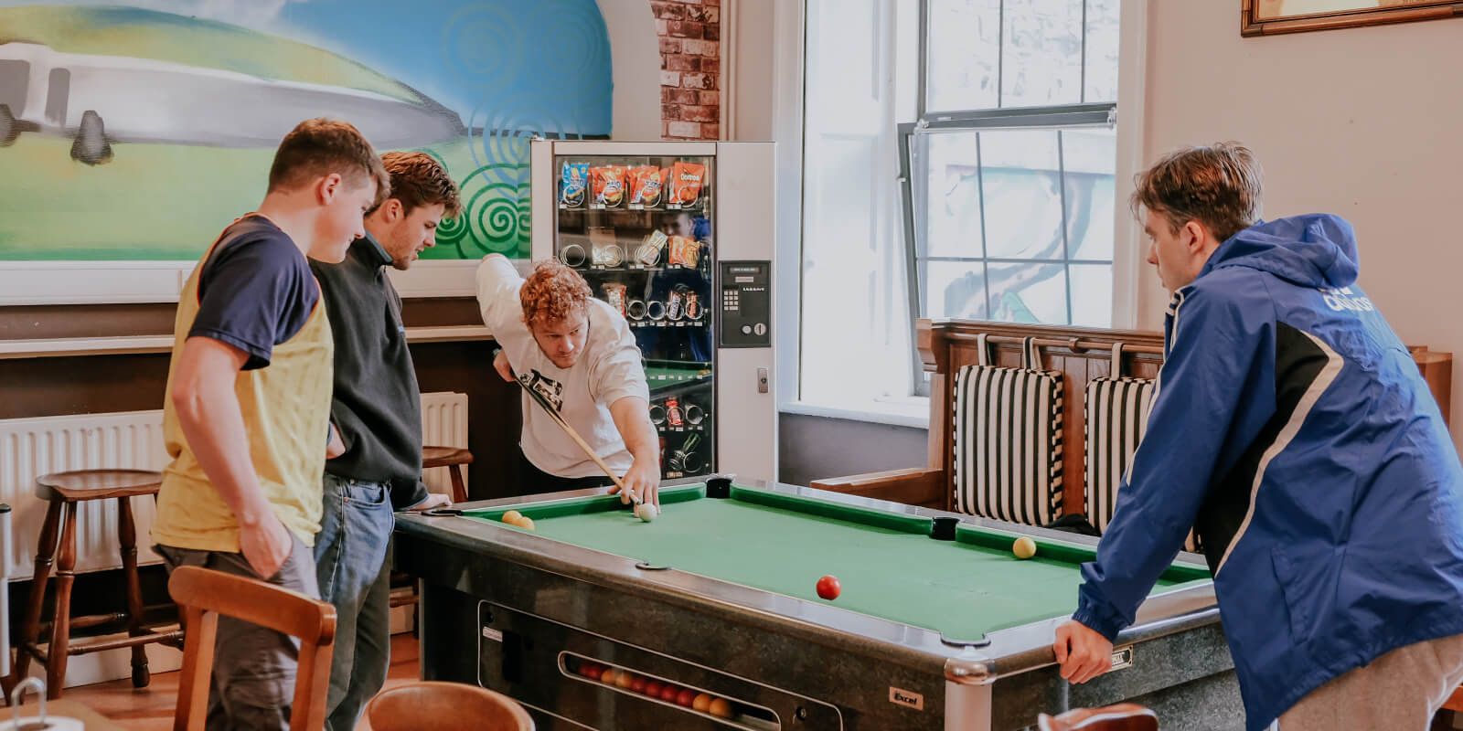 Guests playing pool at Gardiner House Hostel in Dublin