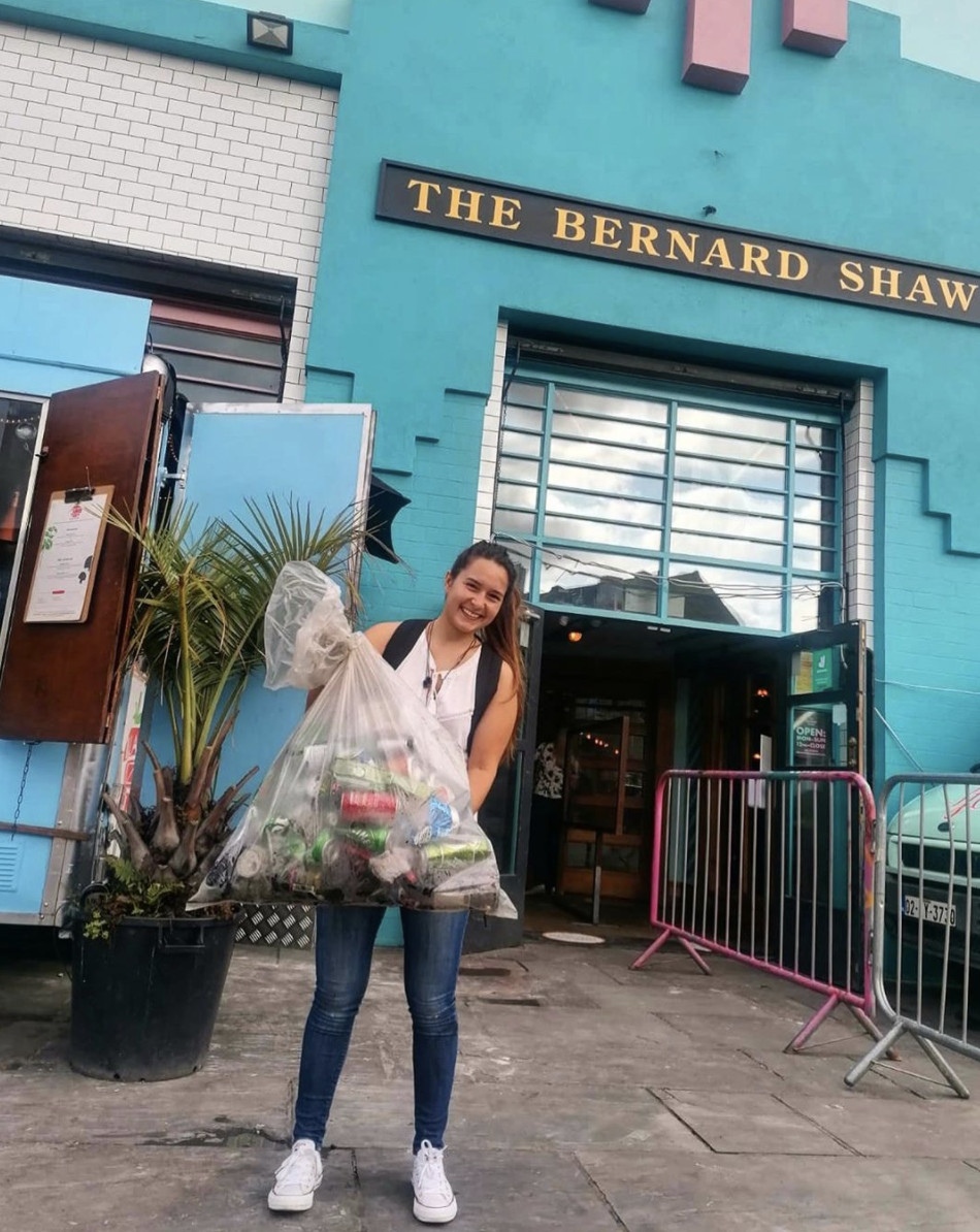 Girl with a bag full of rubbish collected from the Royal Canal, Dublin, Ireland