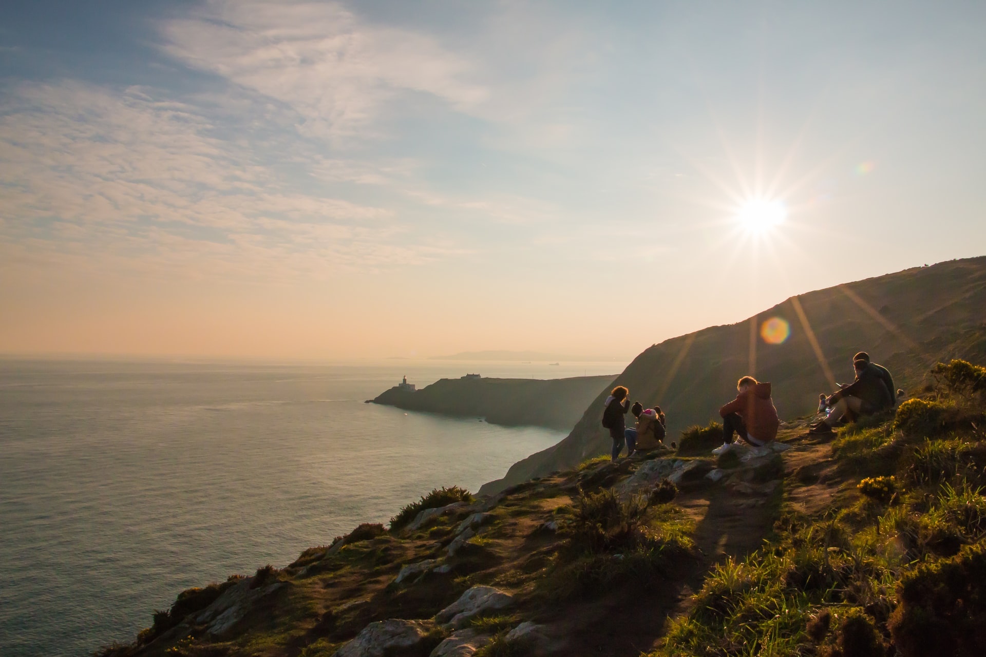 Group of friends at the edge of Howth Cliff Walk during sunset
