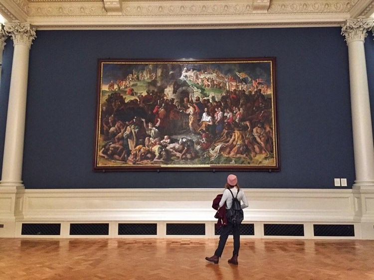 Girl standing in front of painting at the National Gallery of Ireland