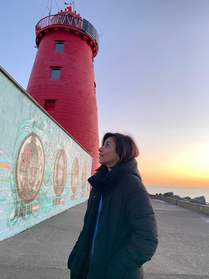 Girl posing in front of the Poolbeg Lighthouse, Dublin, Ireland