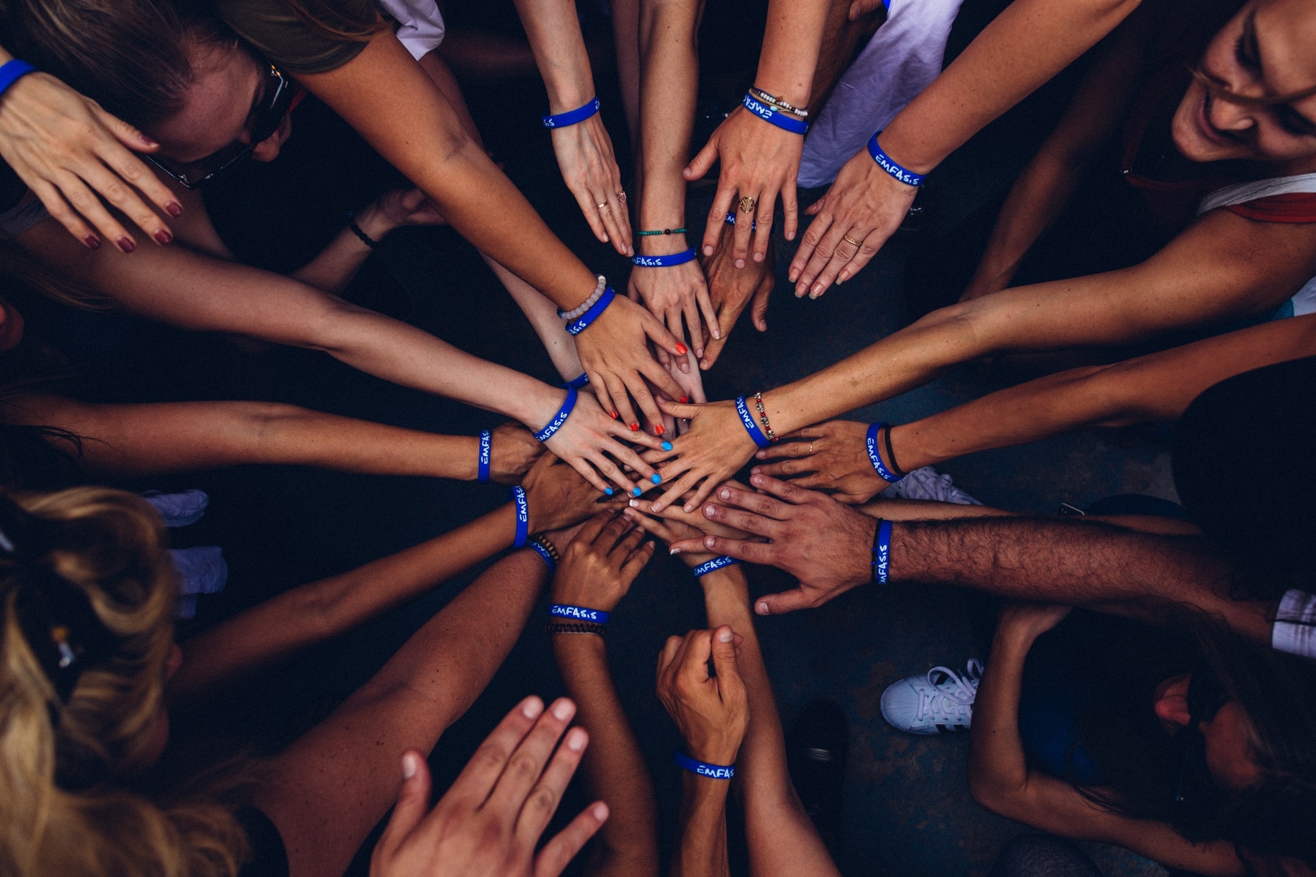 People bringing their hands together in a sign of team work and union