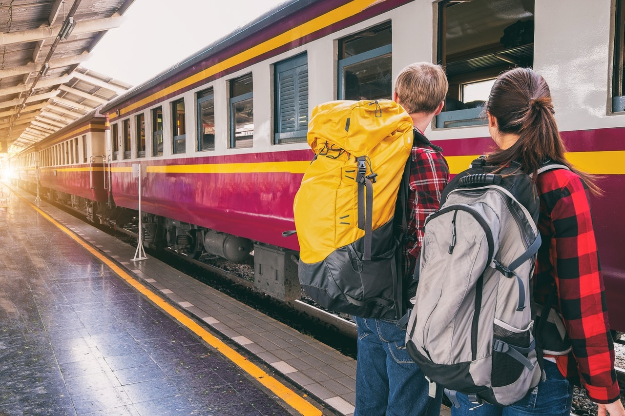 Two backpackers waiting to catch the train