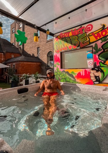 Boy inside a jaccuzi enjoying a sunny day in Gardiner House Hostel in Dublin