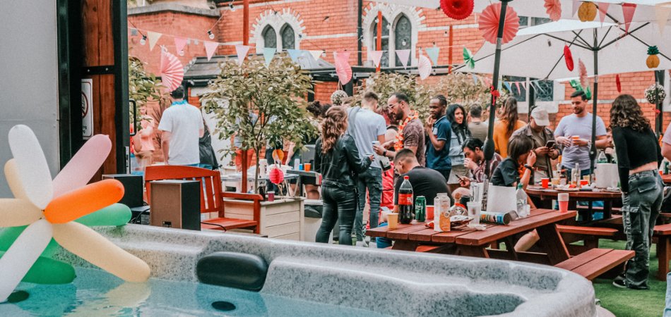 People sitting in outdoor garden enjoying a party